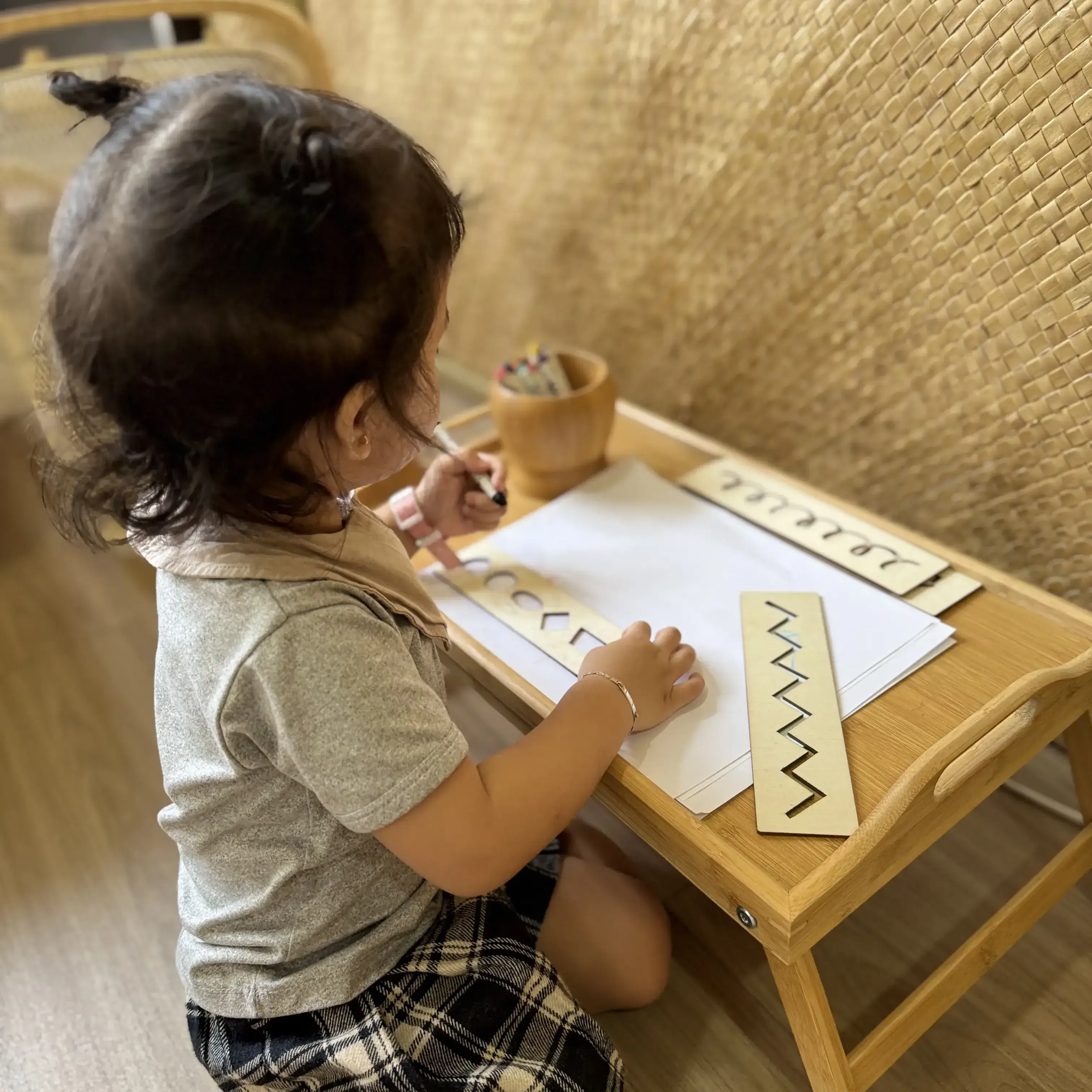 Teacher guiding children with materials